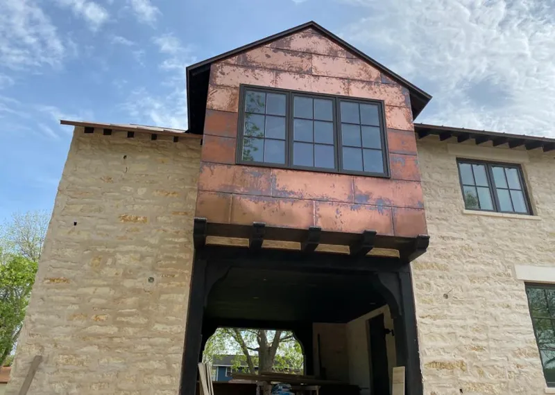 Copper metal panel facade on a stone building for Roof Repair in Chino Hills