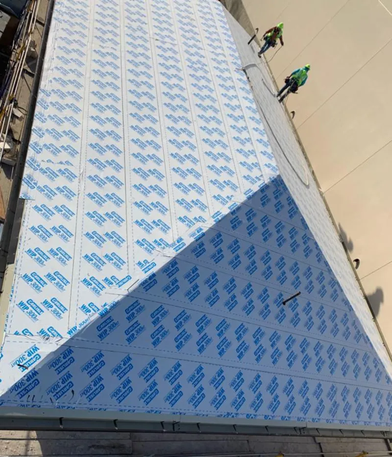 Professional roofers installing underlayment on a metal roof in Chino Hills